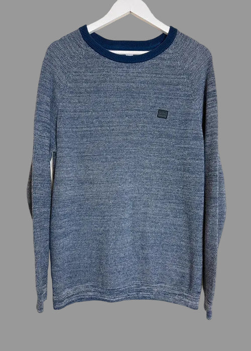 Blue sweater on a hanger against a beige background