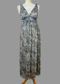 Floral patterned dress on a mannequin against a plain wall.